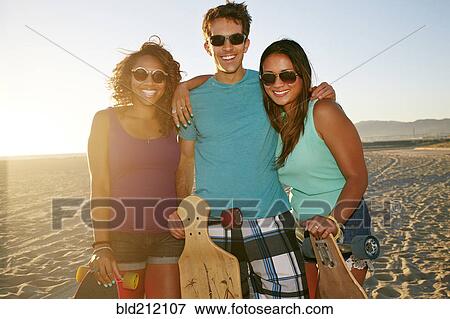 Friends smiling on beach View Large Photo Image Stock Photo - Friends smiling on beach. Fotosearch