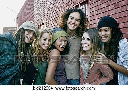 Friends smiling together on city street View Large Photo Image Picture - Friends smiling together on city street. Fotosearch