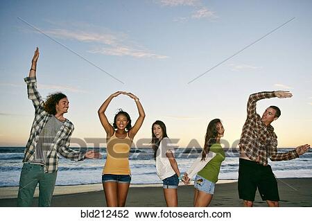 Friends spelling Love on beach View Large Photo Image Stock Image - Friends spelling Love on beach. Fotosearch