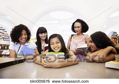 Stock Photograph - Girl checking out books from library. Fotosearch