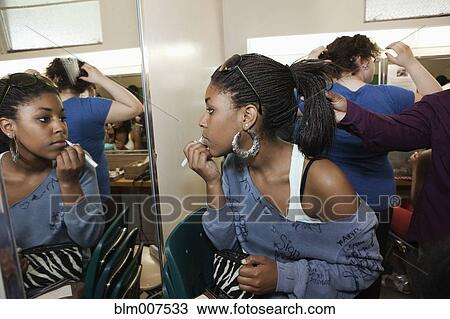Stock Image - Girls getting ready backstage. Fotosearch