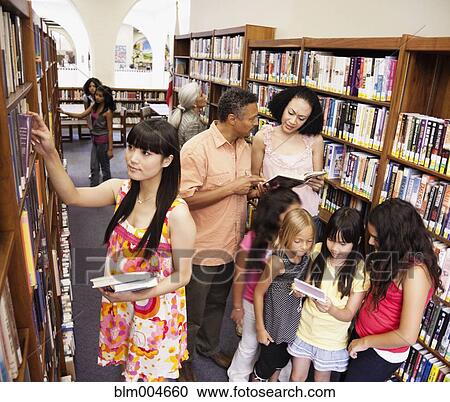 Girls looking at video game in library View Large Photo Image Stock Image - Girls looking at video game in library. Fotosearch