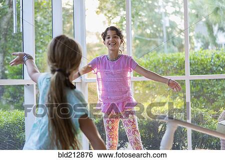Girls playing together on porch View Large Photo Image Stock Photograph - Girls playing together on porch. Fotosearch