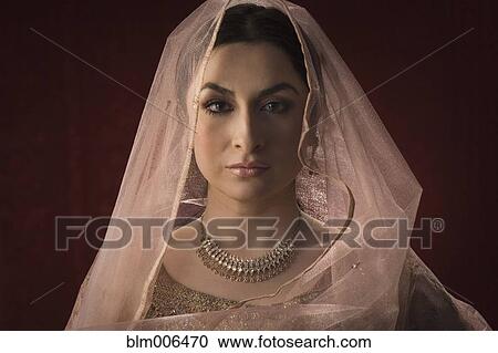 Glamorous Middle Eastern woman in ornate dress and veil View Large Photo Image Stock Image - Glamorous Middle Eastern woman in ornate dress and veil. Fotosearch