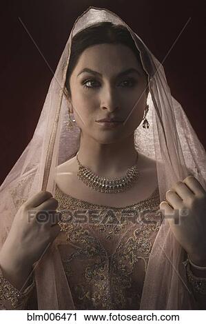 Glamorous Middle Eastern woman in ornate dress and veil View Large Photo Image Stock Image - Glamorous Middle Eastern woman in ornate dress and veil. Fotosearch