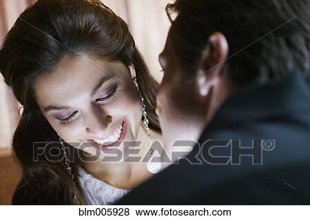Glamorous woman smiling at husband View Large Photo Image Stock Photo - Glamorous woman smiling at husband. Fotosearch