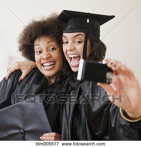 Stock Photo - Graduating friends taking self-portrait. Fotosearch