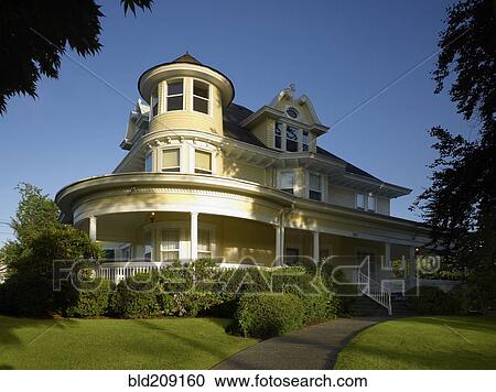 Stock Image - Grand Victorian house with green lawn. Fotosearch