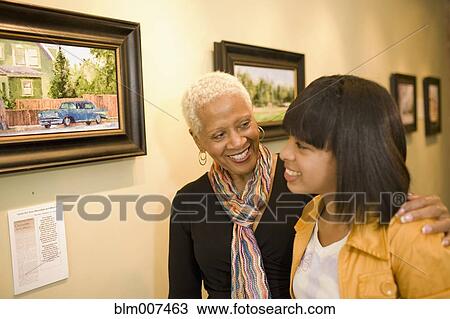 Grandmother and granddaughter hugging in gallery View Large Photo Image Stock Image - Grandmother and granddaughter hugging in gallery. Fotosearch