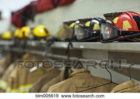 Helmets and coats in fire station View Large Photo Image Stock Photo - Helmets and coats in fire station. Fotosearch