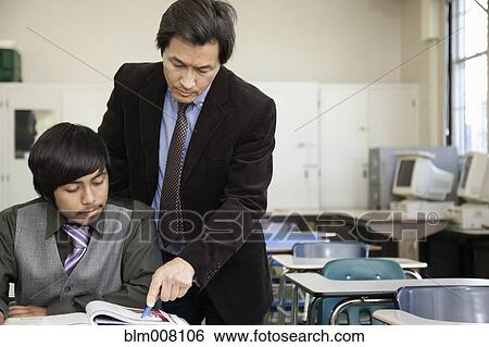 Stock Photograph - High school student listening to teacher. Fotosearch