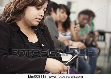 High school student using cell phone in classroom View Large Photo Image Stock Photo - High school student using cell phone in classroom. Fotosearch