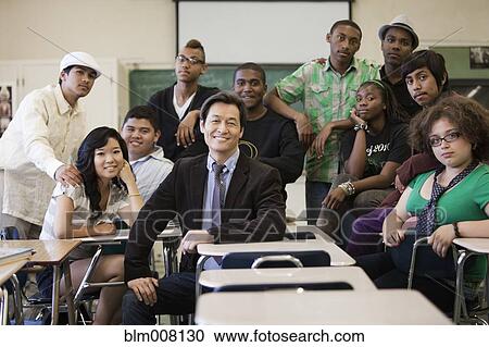Stock Image - High school students and teacher in classroom. Fotosearch