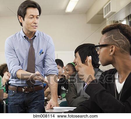 Picture - High school students listening to teacher. Fotosearch
