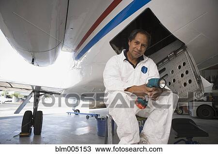 Hispanic airplane mechanic repairing plane View Large Photo Image Stock Image - Hispanic airplane mechanic repairing plane. Fotosearch