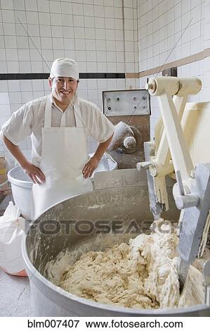 Hispanic baker mixing dough View Large Photo Image Stock Photo - Hispanic baker mixing dough. Fotosearch