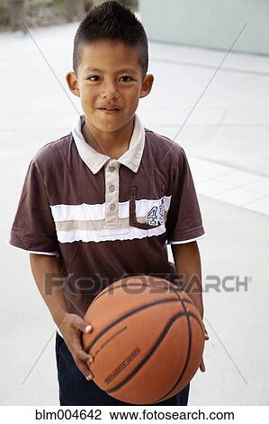 Hispanic boy holding basketball View Large Photo Image Stock Image - Hispanic boy holding basketball. Fotosearch