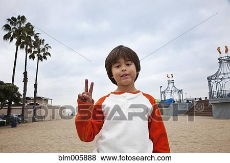 Hispanic boy making peace sign View Large Photo Image Stock Photo - Hispanic boy making peace sign. Fotosearch