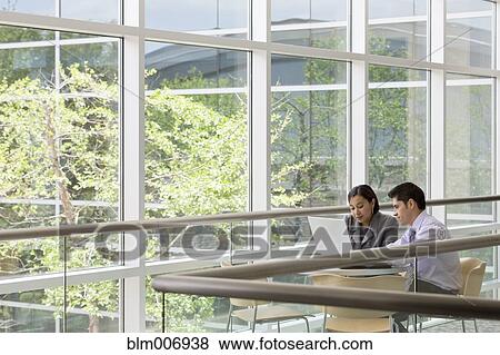 Hispanic business people working together in cafe View Large Photo Image Stock Photo - Hispanic business people working together in cafe. Fotosearch