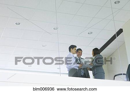 Stock Photograph - Hispanic business people working together. Fotosearch