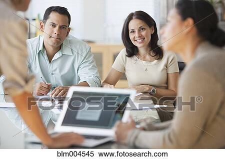 Stock Photography - Hispanic business people working together. Fotosearch