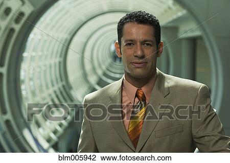 Hispanic businessman in round corridor View Large Photo Image Stock Image - Hispanic businessman in round corridor. Fotosearch