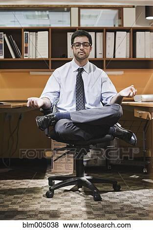 Hispanic businessman meditating at desk View Large Photo Image Stock Photo - Hispanic businessman meditating at desk. Fotosearch