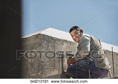 Stock Image - Hispanic construction worker at construction site. Fotosearch