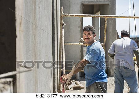 Stock Photo - Hispanic construction worker at construction site. Fotosearch