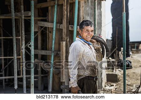 Stock Photo - Hispanic construction worker at construction site. Fotosearch
