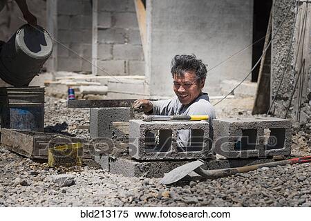 Stock Photography - Hispanic construction worker at construction site. Fotosearch