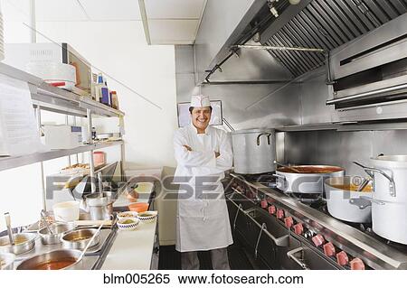 Stock Photography - Hispanic cook in commercial kitchen. Fotosearch