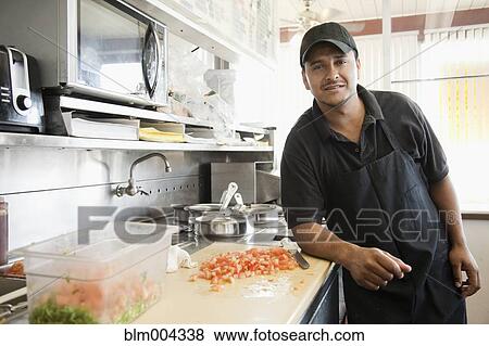 Stock Photo - Hispanic cook in diner kitchen. Fotosearch