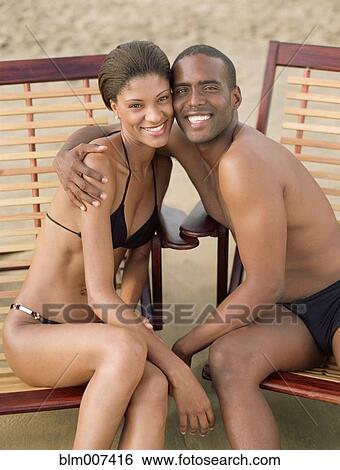 Hispanic couple in swimsuits hugging View Large Photo Image Stock Photograph - Hispanic couple in swimsuits hugging. Fotosearch