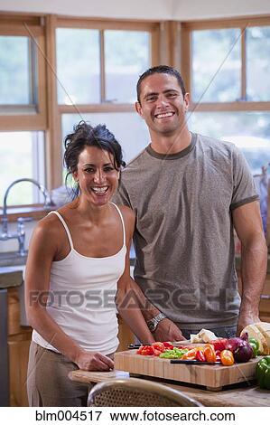 Stock Photo - Hispanic couple preparing healthy meal. Fotosearch