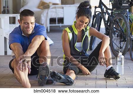 Stock Photo - Hispanic couple resting after bike ride. Fotosearch
