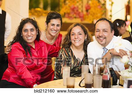 Hispanic family smiling at wedding reception View Large Photo Image Stock Image - Hispanic family smiling at wedding reception. Fotosearch