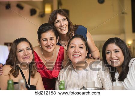 Stock Photo - Hispanic family smiling at wedding reception. Fotosearch