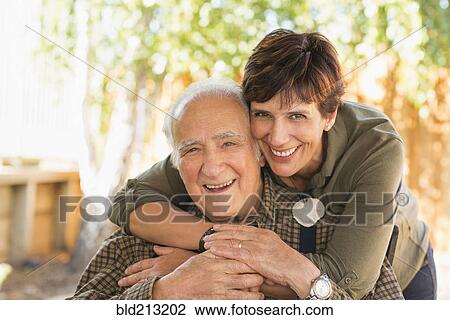 Stock Image - Hispanic father and daughter hugging. Fotosearch
