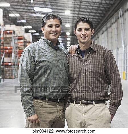 Hispanic father and son in warehouse View Large Photo Image Stock Image - Hispanic father and son in warehouse. Fotosearch