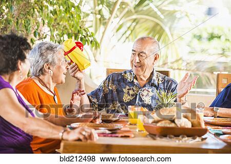 Stock Photo - Hispanic friends celebrating birthday. Fotosearch