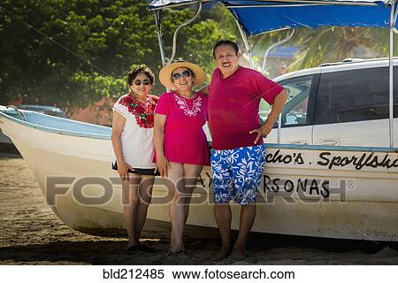 Hispanic friends smiling by boat on beach View Large Photo Image Stock Photography - Hispanic friends smiling by boat on beach. Fotosearch