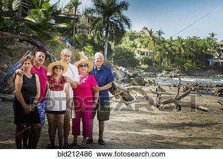 Hispanic friends smiling together on beach View Large Photo Image Stock Photograph - Hispanic friends smiling together on beach. Fotosearch