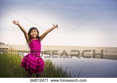 Hispanic girl cheering by still water View Large Photo Image Stock Image - Hispanic girl cheering by still water. Fotosearch
