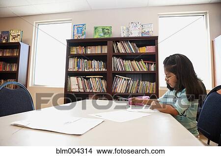 Hispanic girl doing homework in library View Large Photo Image Picture - Hispanic girl doing homework in library. Fotosearch