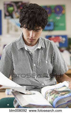 Hispanic high school student reading textbook View Large Photo Image Stock Image - Hispanic high school student reading textbook. Fotosearch