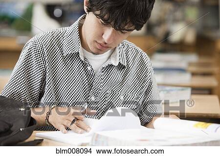 Hispanic high school student studying at desk View Large Photo Image Picture - Hispanic high school student studying at desk. Fotosearch