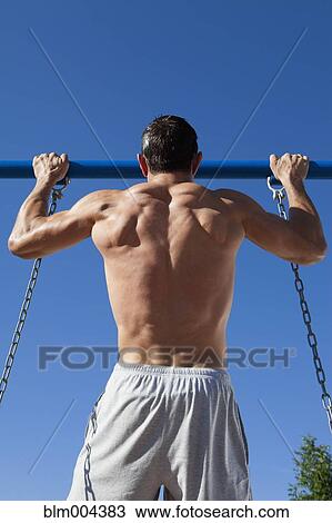 Hispanic man doing pull-ups on swing set bar View Large Photo Image Stock Image - Hispanic man doing pull-ups on swing set bar. Fotosearch