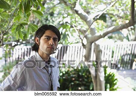 Hispanic man frowning outdoors View Large Photo Image Stock Image - Hispanic man frowning outdoors. Fotosearch