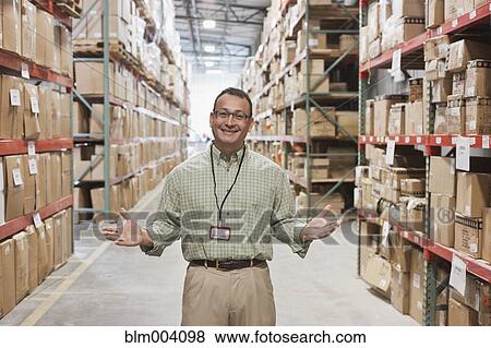 Hispanic man gesturing in warehouse View Large Photo Image Stock Photo - Hispanic man gesturing in warehouse. Fotosearch